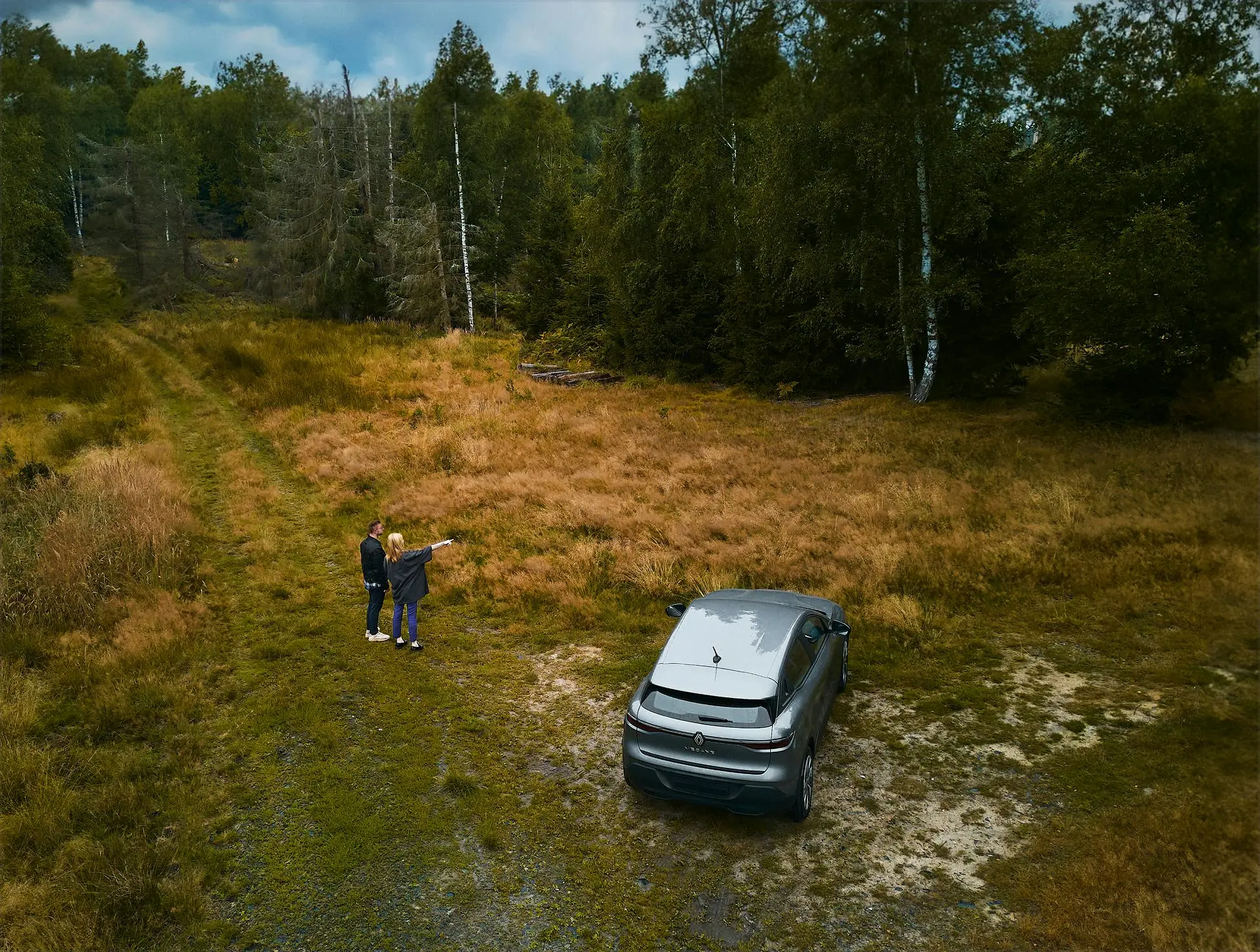 Couple and a car in nature
