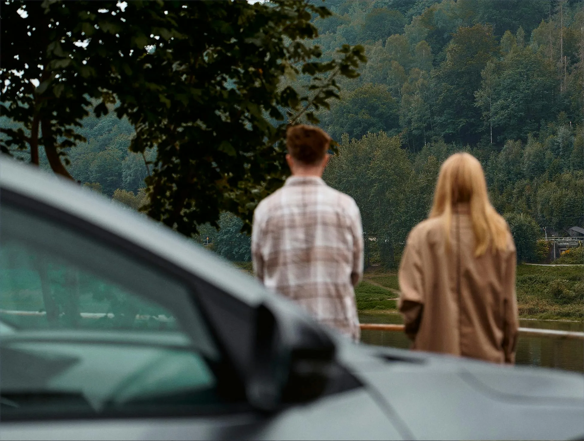 Couple behind a car