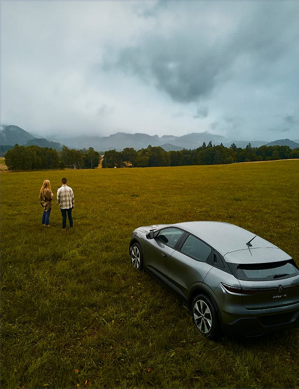 Car and a couple on a field