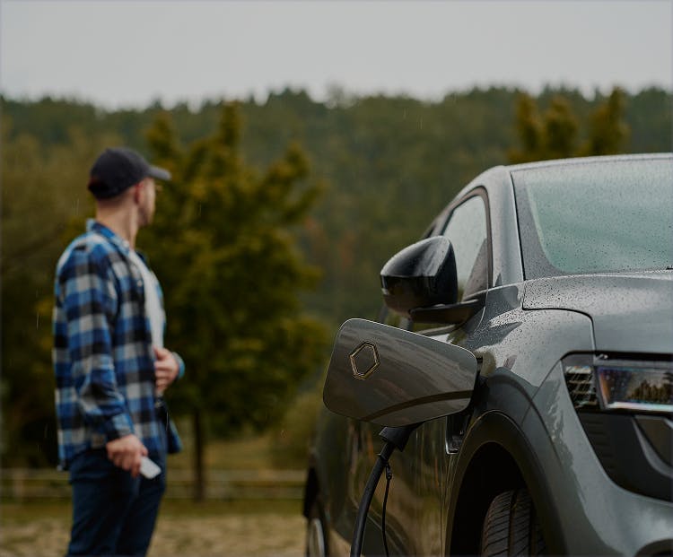 Man standing besides a car